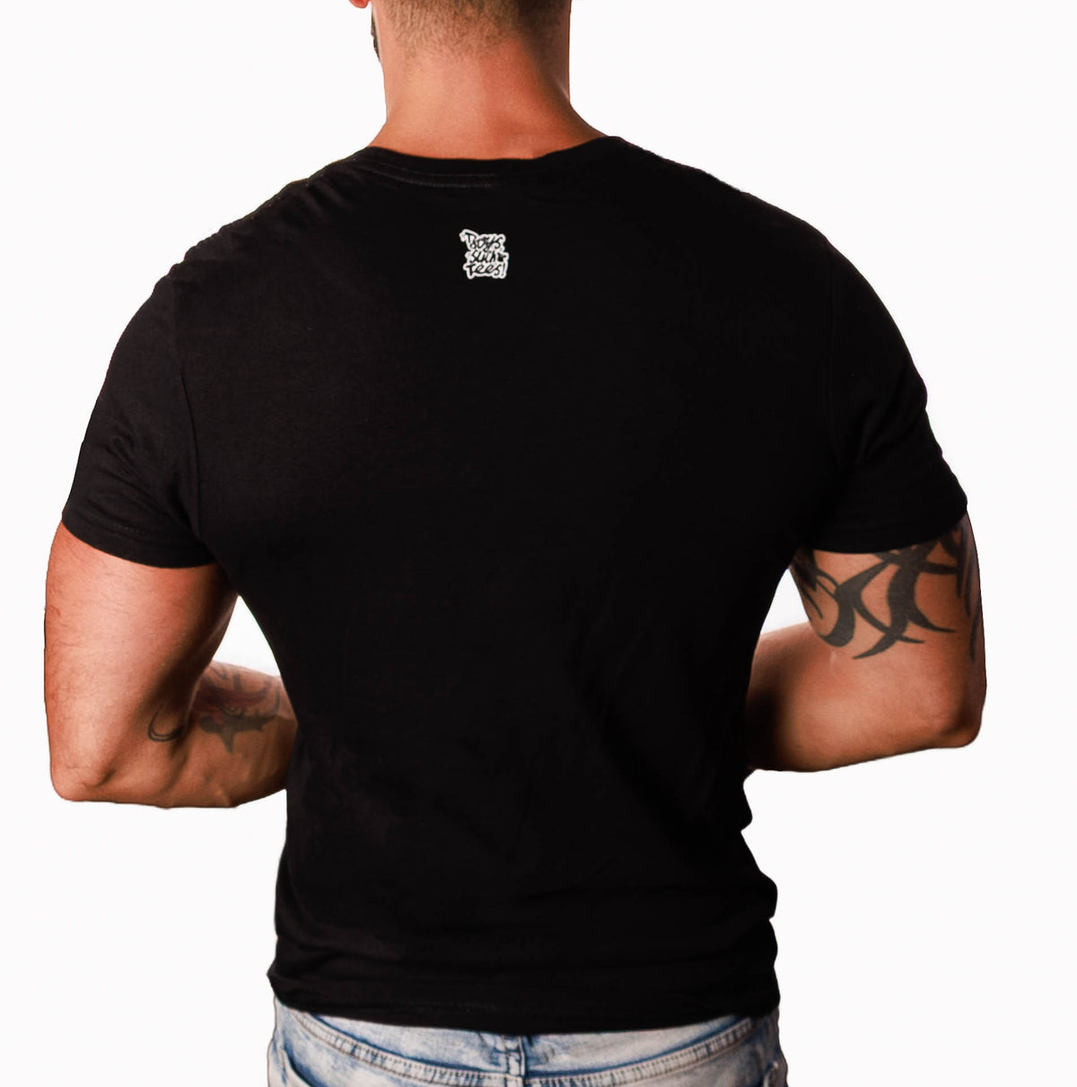 A man viewed from the back wearing a fitted black short-sleeve t-shirt with a small white graphic logo centered on the upper back, paired with light blue jeans against a plain white background.
