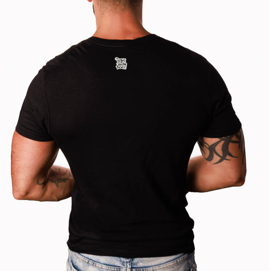 A man viewed from the back wearing a fitted black short-sleeve t-shirt with a small white graphic logo centered on the upper back, paired with light blue jeans against a plain white background.