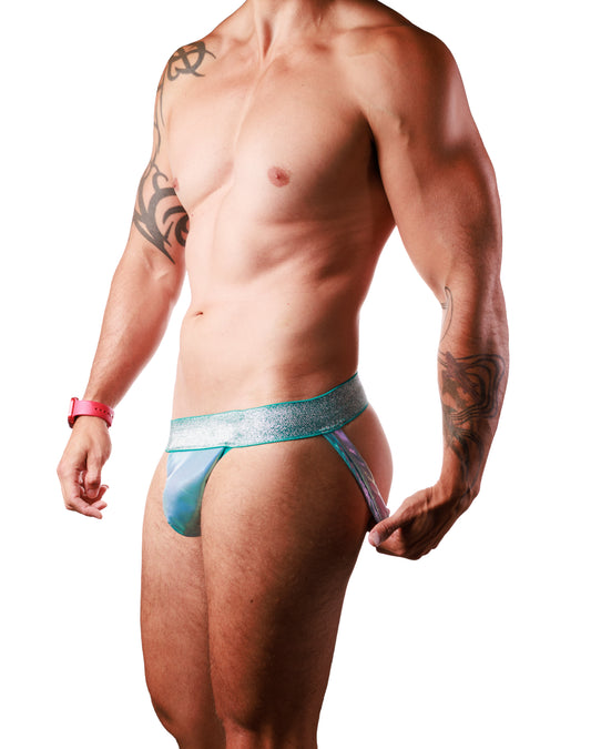 A muscular man wearing a light blue and teal patterned jockstrap, shown from the chest down against a solid white background.