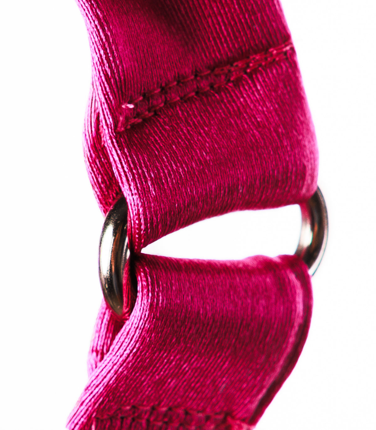 A close-up of a bright magenta pink woven strap with a silver metal ring, shown against a plain white background.