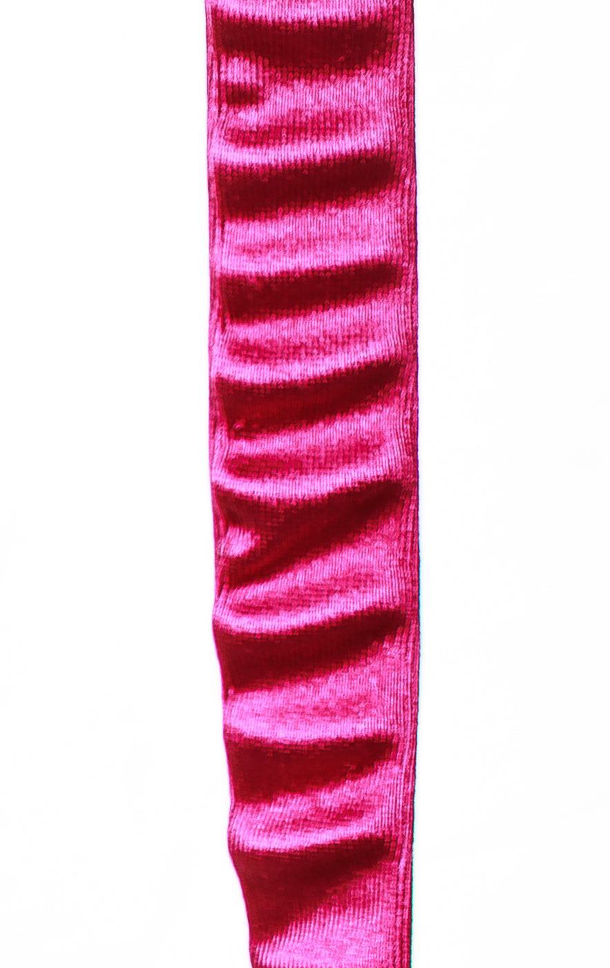 A close-up vertical view of a bright pink velvet ribbon or trim with a textured, shimmering surface on a plain white background.