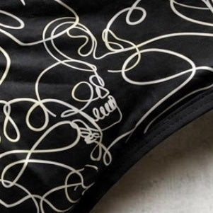 Skull & Mischief takes a classic black base and transforms it with intricate, flowing lines that reveal skull shapes throughout the pattern. Artistic from afar and full of detail up close, this design finds the sweet spot between dark aesthetics and playful rebellion.