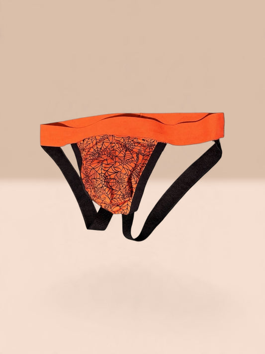 One side keeps things dark and mysterious with a black base and flowing gold-toned scribbles. Flip it inside out, and you're ready to bring the heat with bold orange spiderwebs against a Halloween-inspired print.