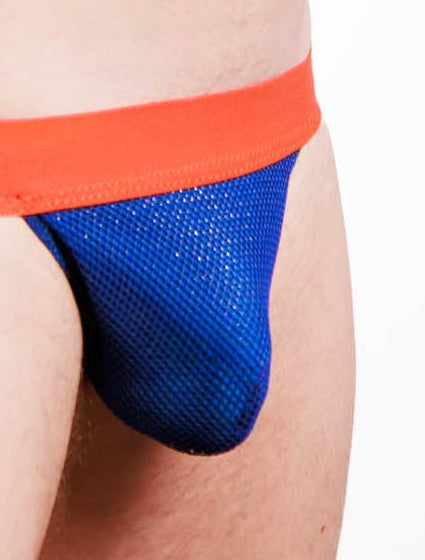 A man wearing a men's jockstrap with a bright orange waistband and a blue mesh pouch, shown from the chest down against a white studio background.